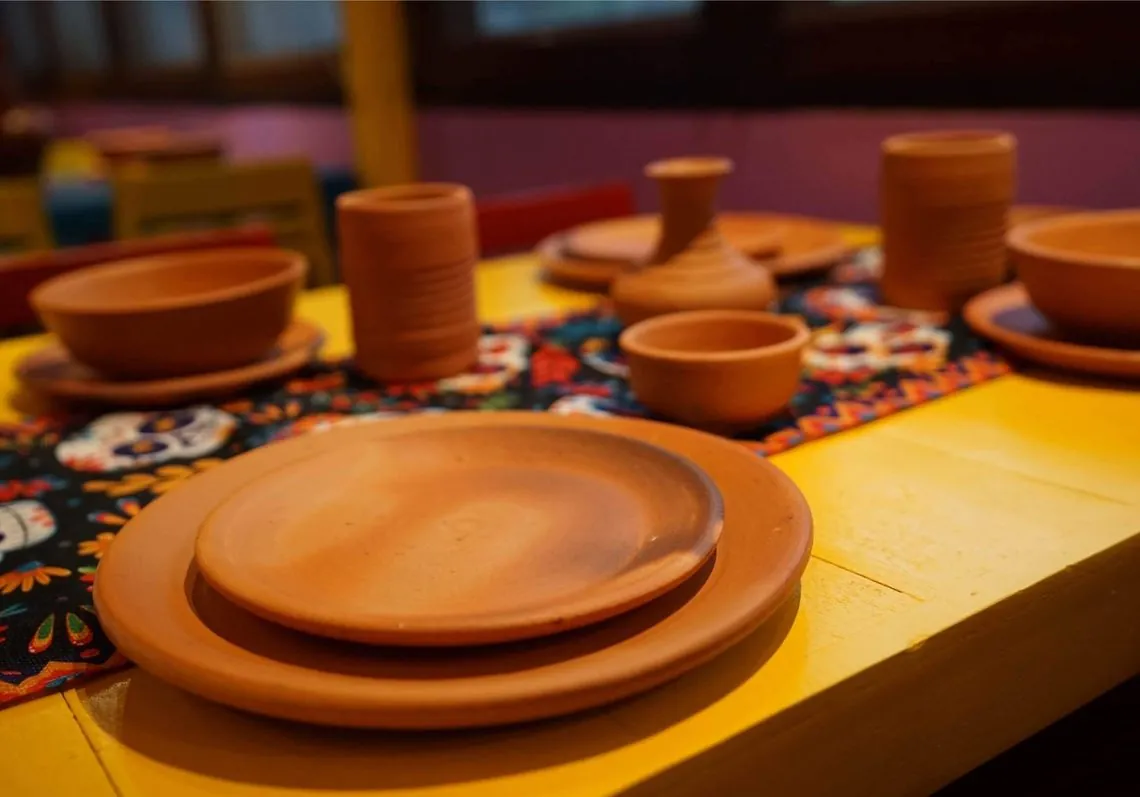 Handmade clay plates and bowls used to serve food at Danzante Bangkok