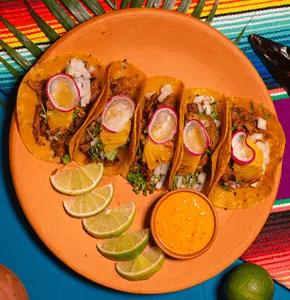 Tacos al Pastor — pork marinated with Mexican dried peppers in corn tortillas